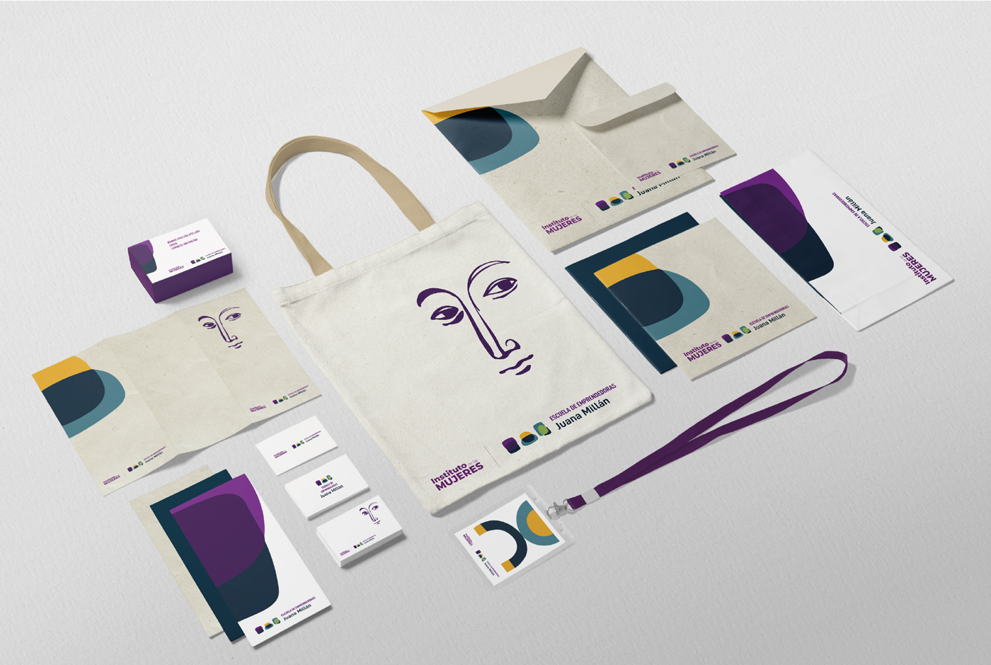 Ejemplo de aplicación de Identidad de la Escuela de emprendedoras Juana Millán en diferentes materiales: Bolsa de tela, triptico, tarjetas de visita, acreditación, sobre, díptico